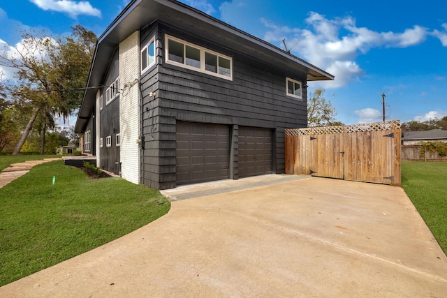 view of side of property with a yard and a garage