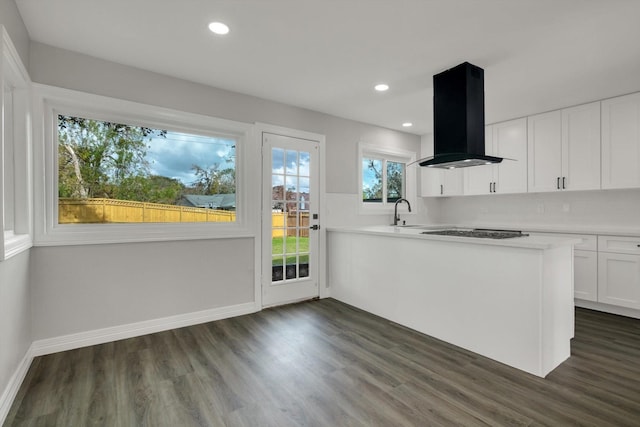 kitchen featuring gas cooktop, dark hardwood / wood-style flooring, island range hood, and white cabinetry