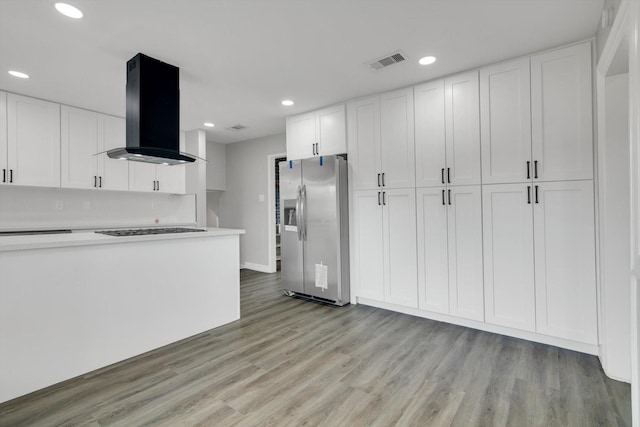 kitchen with white gas cooktop, stainless steel refrigerator with ice dispenser, ventilation hood, white cabinets, and light wood-type flooring