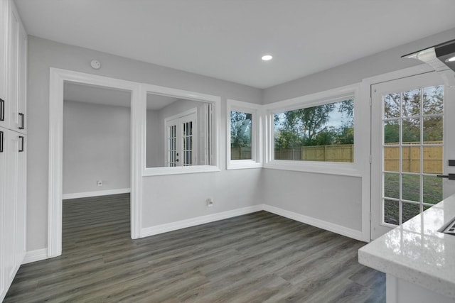 unfurnished dining area featuring dark hardwood / wood-style floors