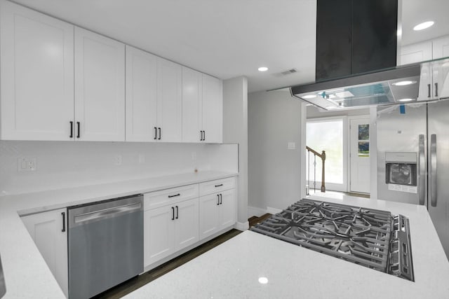 kitchen featuring white cabinetry, dark wood-type flooring, gas cooktop, stainless steel dishwasher, and exhaust hood