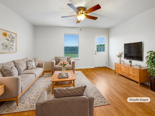 living room featuring ceiling fan and light hardwood / wood-style floors