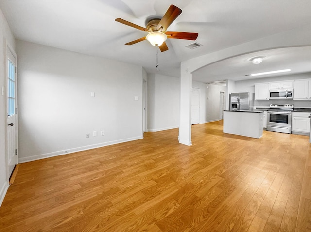 kitchen featuring white cabinets, ceiling fan, light hardwood / wood-style floors, and appliances with stainless steel finishes