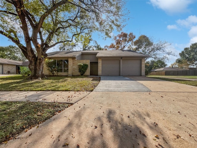 ranch-style house with a garage and a front lawn