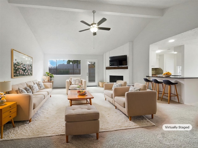 carpeted living room with ceiling fan, beamed ceiling, high vaulted ceiling, and a brick fireplace