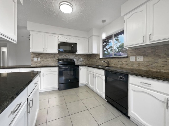 kitchen with pendant lighting, sink, white cabinetry, and black appliances