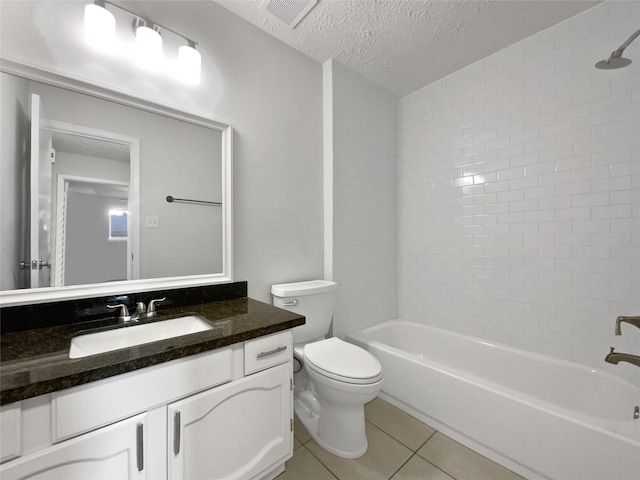 full bathroom with vanity, a textured ceiling, tile patterned flooring, toilet, and tiled shower / bath