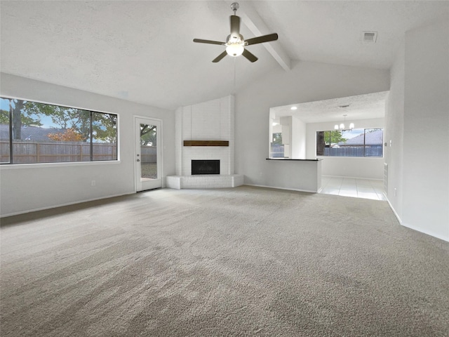 unfurnished living room with a brick fireplace, vaulted ceiling with beams, light colored carpet, a textured ceiling, and ceiling fan with notable chandelier