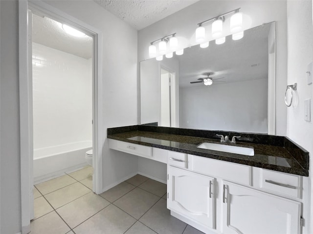 full bathroom with ceiling fan, tile patterned flooring, vanity, and a textured ceiling