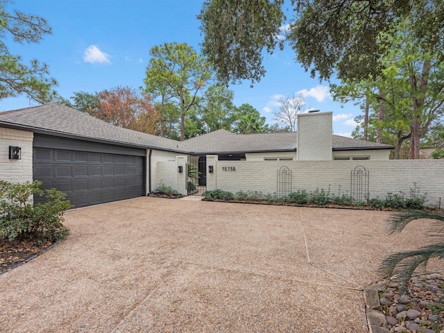 ranch-style home featuring a garage