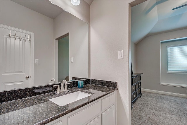 bathroom with vanity and vaulted ceiling