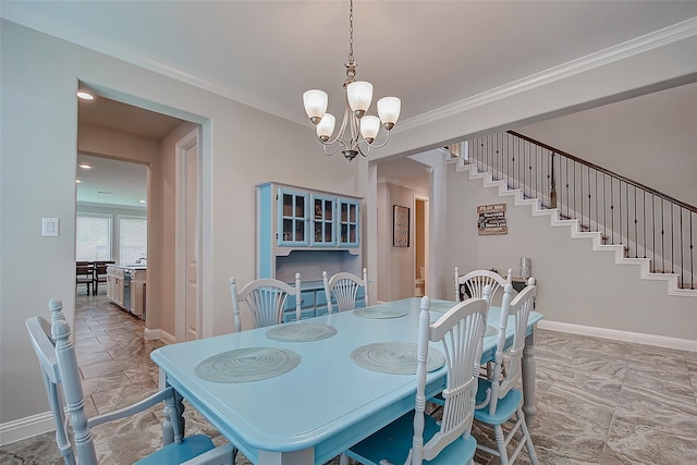 dining space featuring ornamental molding and a notable chandelier