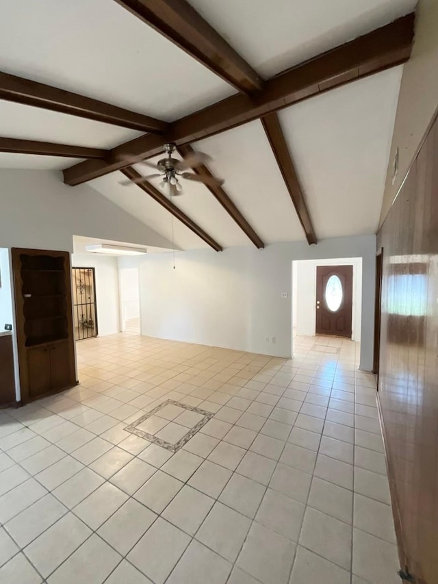 unfurnished living room featuring vaulted ceiling with beams, ceiling fan, and light tile patterned floors