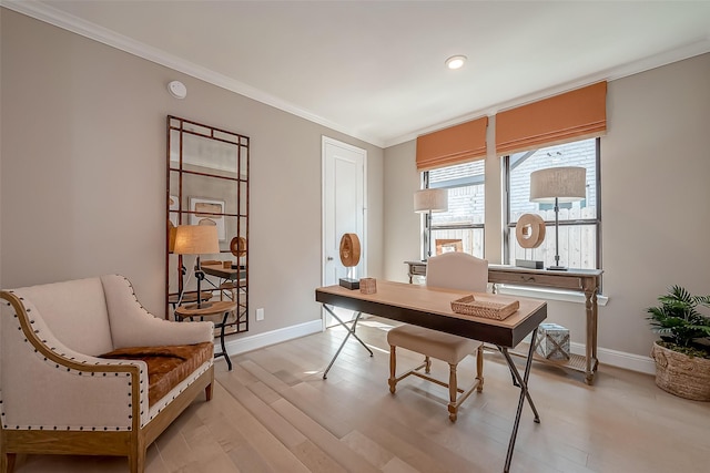 office area featuring light wood-type flooring and crown molding