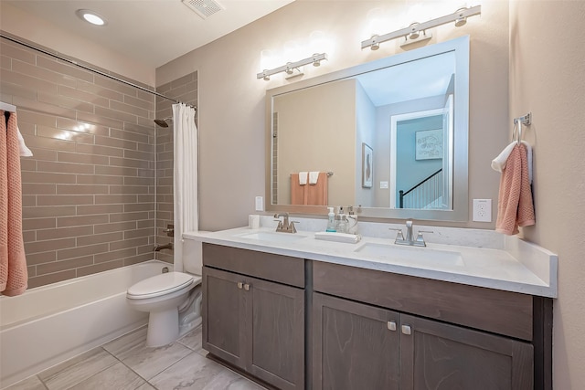 full bathroom featuring vanity, shower / tub combo, and toilet