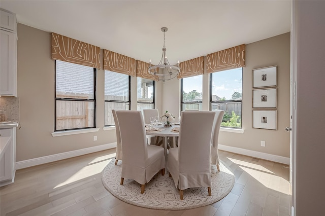 dining room featuring light hardwood / wood-style flooring and a chandelier