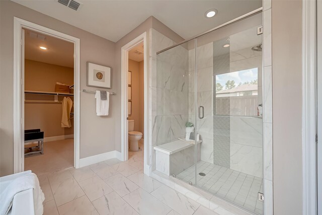 bathroom with toilet and an enclosed shower