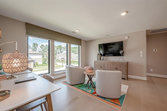 living room with light hardwood / wood-style flooring