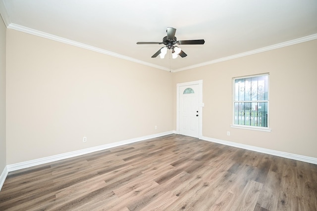 spare room with hardwood / wood-style floors, ceiling fan, and ornamental molding