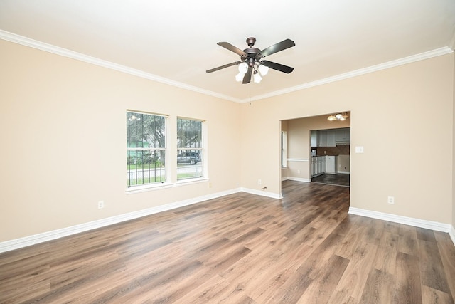 unfurnished room with crown molding, dark hardwood / wood-style flooring, and ceiling fan