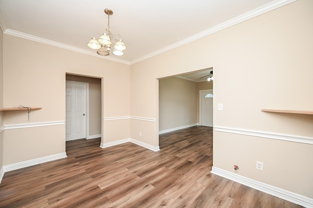 unfurnished dining area featuring ceiling fan with notable chandelier, hardwood / wood-style flooring, and ornamental molding