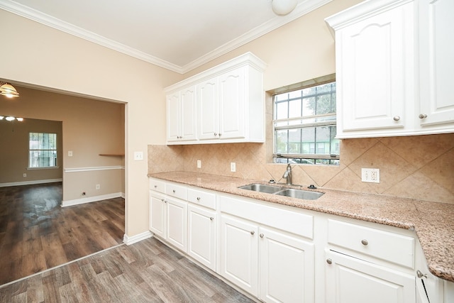 kitchen featuring sink, dark wood-type flooring, decorative backsplash, white cabinets, and ornamental molding