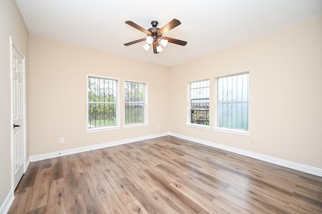 empty room with ceiling fan and light wood-type flooring