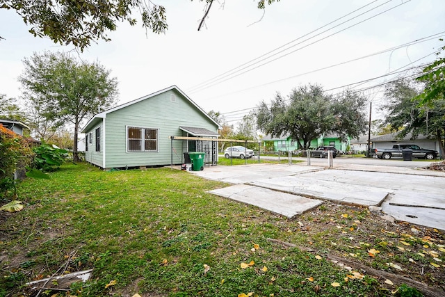 rear view of house featuring a yard