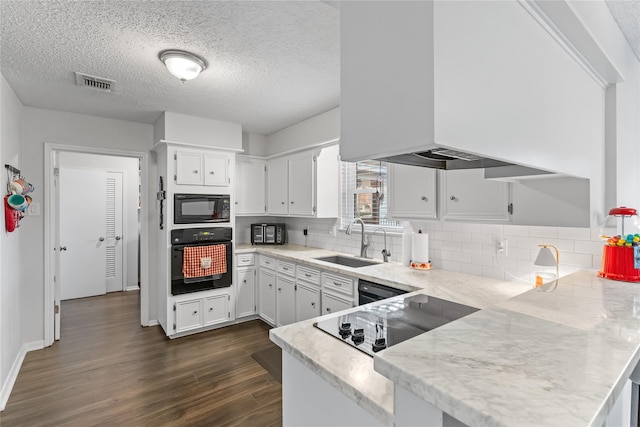 kitchen featuring dark wood-type flooring, white cabinetry, sink, and black appliances