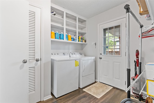 clothes washing area with washer and clothes dryer, dark wood-type flooring, and a textured ceiling