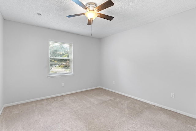 unfurnished room with a textured ceiling, light colored carpet, and ceiling fan