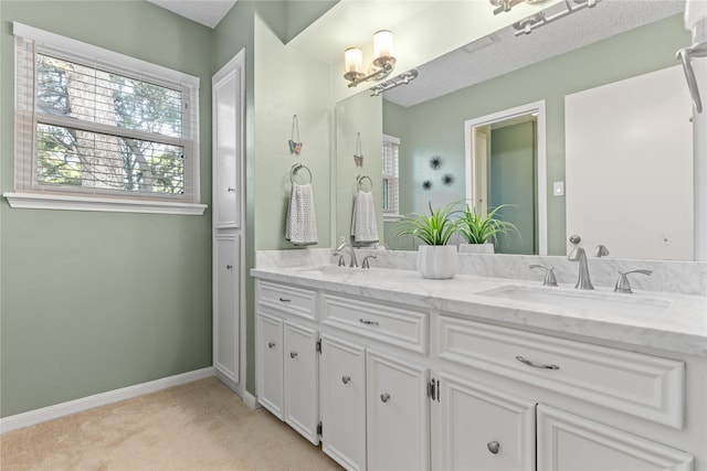 bathroom with vanity and a textured ceiling