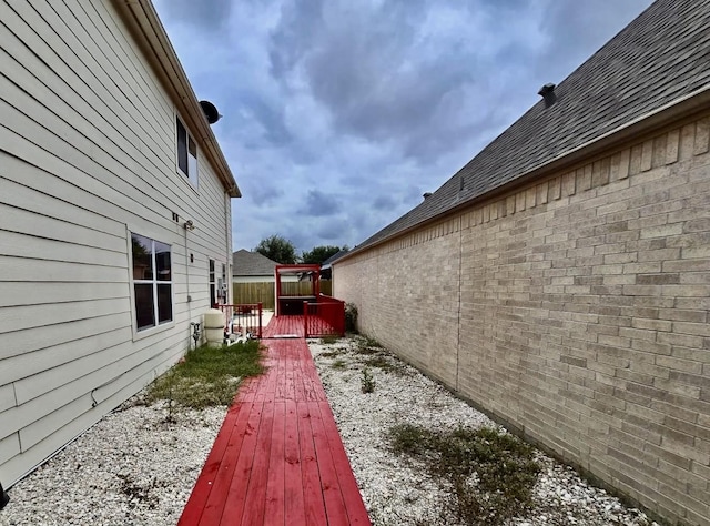 view of property exterior with a deck