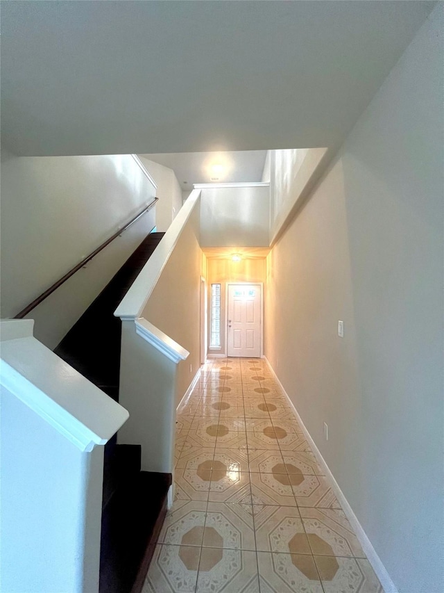 hall with light tile patterned floors