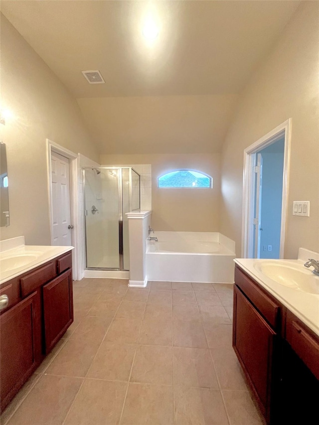 bathroom with tile patterned floors, separate shower and tub, and vaulted ceiling