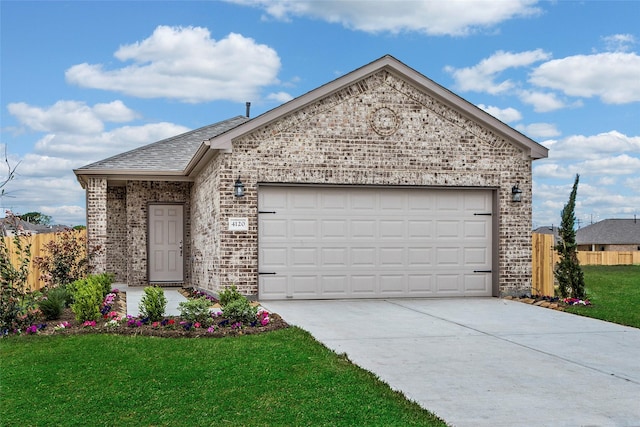 view of front of home featuring a garage and a front lawn