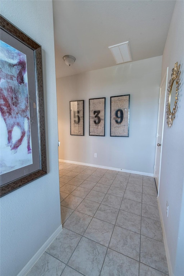 corridor featuring light tile patterned floors