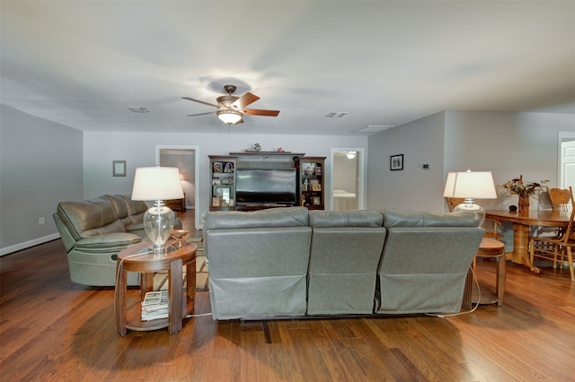 living room featuring hardwood / wood-style floors and ceiling fan