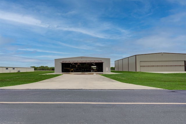 exterior space with a front lawn and an outdoor structure