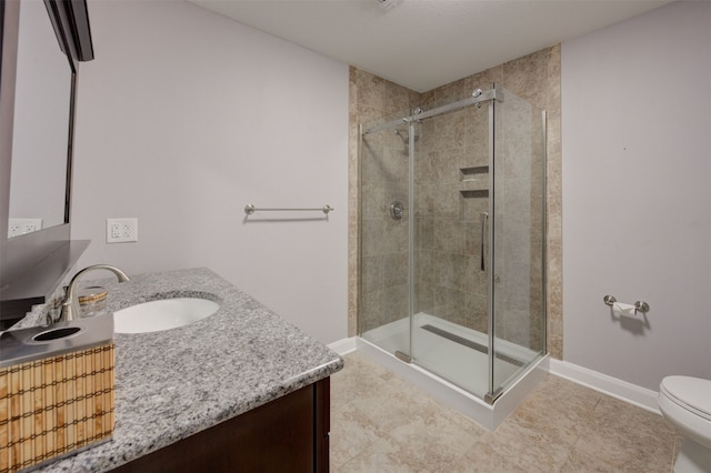 bathroom with tile patterned flooring, vanity, toilet, and walk in shower