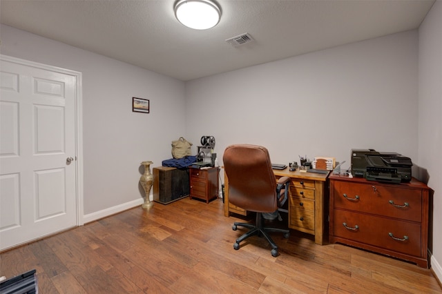 office space with light hardwood / wood-style floors