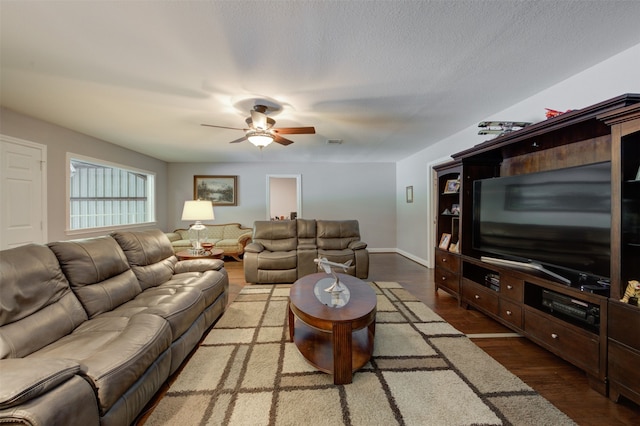 living room with hardwood / wood-style floors, ceiling fan, and a textured ceiling