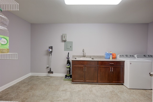 washroom with cabinets, separate washer and dryer, and sink