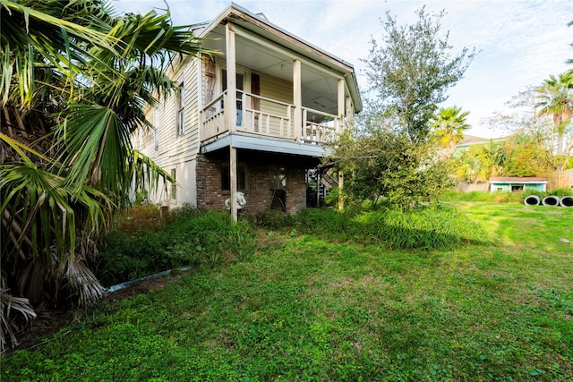 exterior space with a balcony and a yard