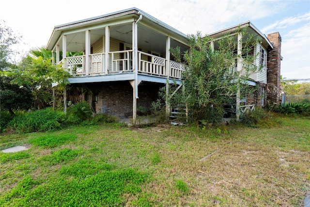 back of property with a lawn