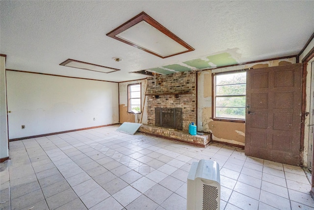 unfurnished living room with light tile patterned flooring, ornamental molding, a textured ceiling, and a brick fireplace