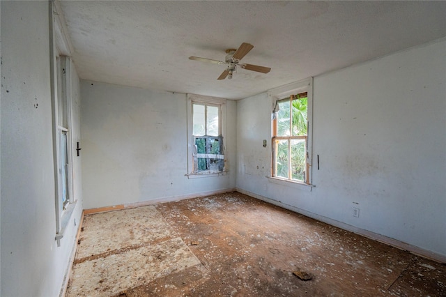 spare room featuring ceiling fan and a textured ceiling