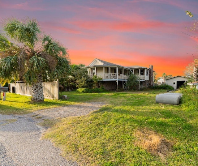 view of front of home featuring a porch and a yard