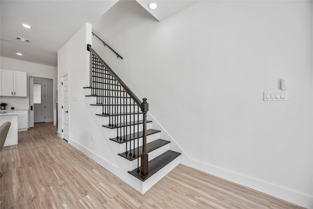 staircase featuring hardwood / wood-style floors