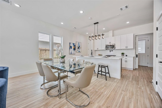 dining area with light hardwood / wood-style flooring